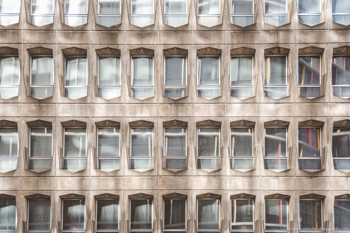 Brutalist architecture in Brussels, Brussels brutalist architecture, brutalist building facade, Brussels architecture photography, geometric building pattern, modernist architecture Belgium, repetitive window pattern, brutalist facade detail, concrete arc