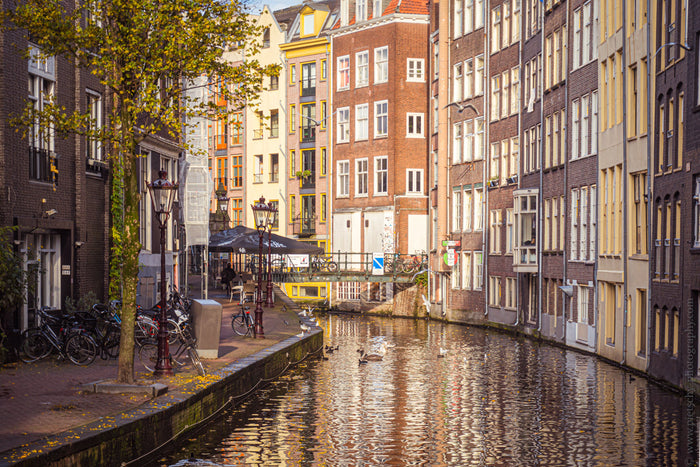 Canal houses in Amsterdam, Dutch canal architecture, Stefanie Pietschmann Photographer, reflective waterways Amsterdam, Pietschy Photography, historic city canals, warm evening cityscape, timeless Amsterdam atmosphere, sustainable wall art, storytelling p