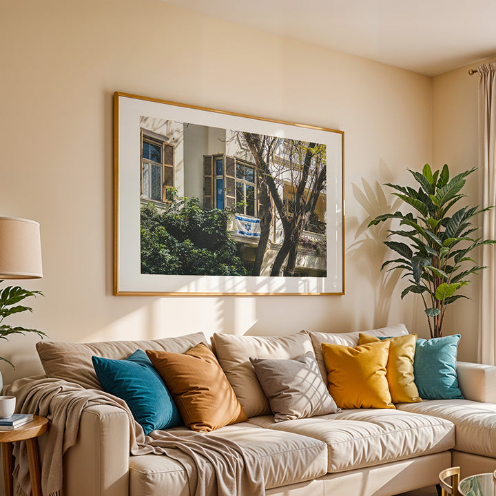 This Tel Aviv Israeli flag wall art captures a quiet moment of city life, where open shutters, soft light, and the Magen David on a balcony come together in a scene full of heritage and warmth. A fine art print that adds meaning, calm, and architectural charm to any space.