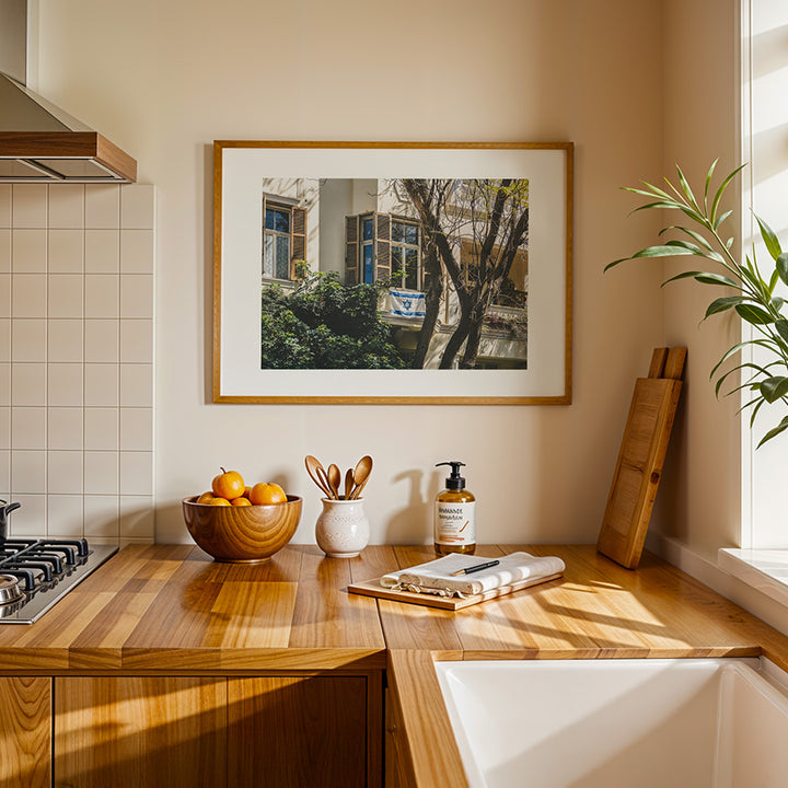 This Tel Aviv Israeli flag wall art captures a quiet moment of city life, where open shutters, soft light, and the Magen David on a balcony come together in a scene full of heritage and warmth. A fine art print that adds meaning, calm, and architectural charm to any space.